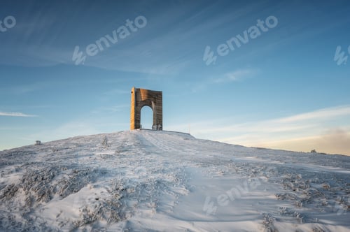 Preview: Monument Arch of Freedom at snow-covered mountain slope