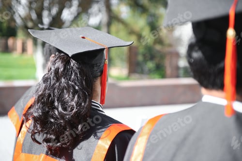 Preview: group of happy international students in mortar boards and bachelor gowns with diplomas
