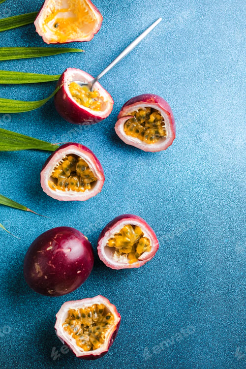 Preview: Ripe passion fruit, half and slice of fruit on a blue background.