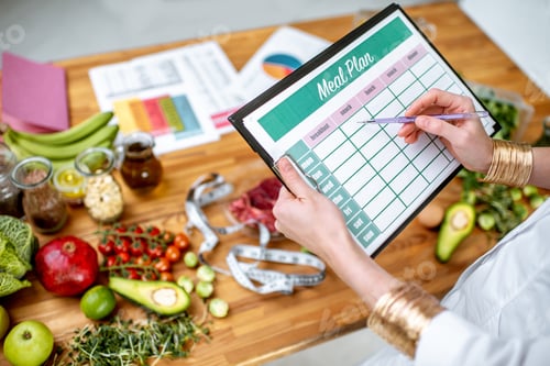 Preview: Writing a diet plan on the table full of healthy food