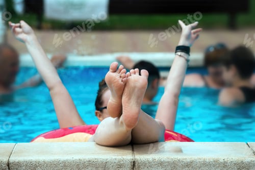 Preview: a beautiful girl swims cheerfully and actively on a circle in the pool
