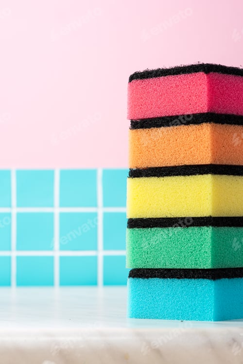 Preview: Colorful cleaning sponge on kitchen counter. Copy space background for mockup