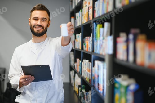 Preview: Pharmacist holding medicine bottle in modern pharmacy