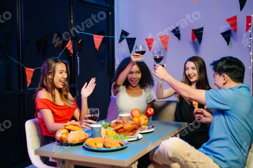 Preview: A diverse group of coworkers enjoying a casual office party or home with drinks, food,