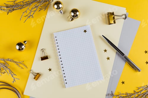 Preview: New year decoration of yellow office desk table with blank notebook