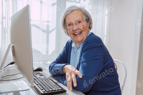 Preview: Cheerful elder grandmother using computer