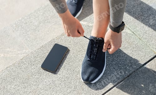 Preview: Healthy lifestyle, sport and exercise. Guy with fitness tracker tie laces on sneakers, telephone on