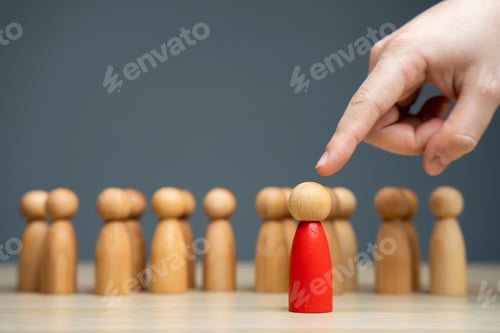 Preview: The hand selects a person from a business team.