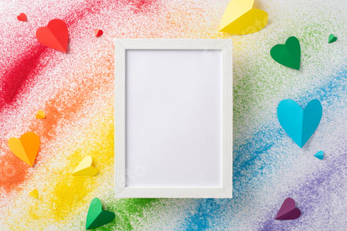 Preview: Colorful sand flag celebrates LGBT history month. Top view captures a vibrant rainbow flag on white