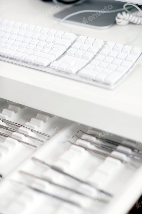 Preview: An open drawer revealing an organized collection of computer keyboards and accessories.