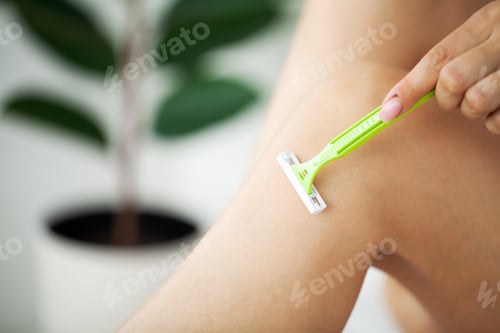 Preview: Skin care and health, fit woman shaving her legs with razor.