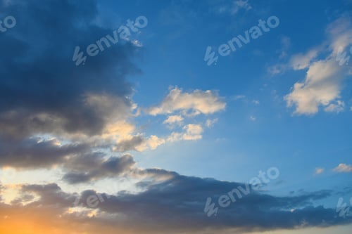 Preview: Blue sky with dark and white fluffy cloud with sunlight in the evening.