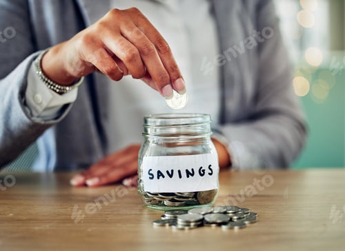 Preview: Putting Coin into Savings Jar on Wooden Table