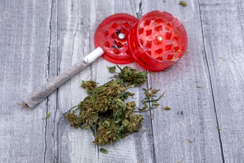 Preview: medical marijuana buds a joint and a red grinder