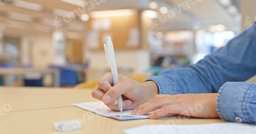 Preview: Woman do her homework at library