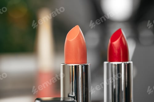 Preview: Pink and red lipsticks on vanity table
