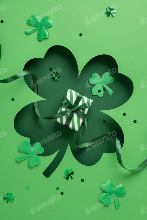 Preview: Green vertical shamrocks surround a small gift wrapped with striped paper