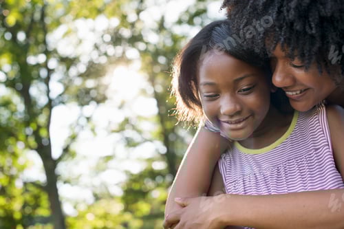 Preview: A young woman and a child hugging.