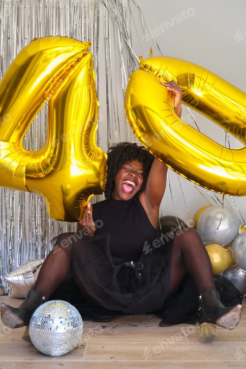 Preview: African woman in a 40 birthday party with 40 birthday golden balloons.