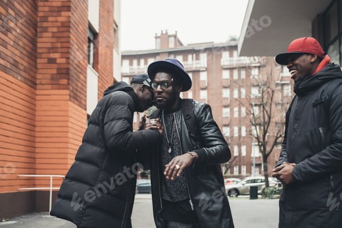 Preview: three african men greeting in the street