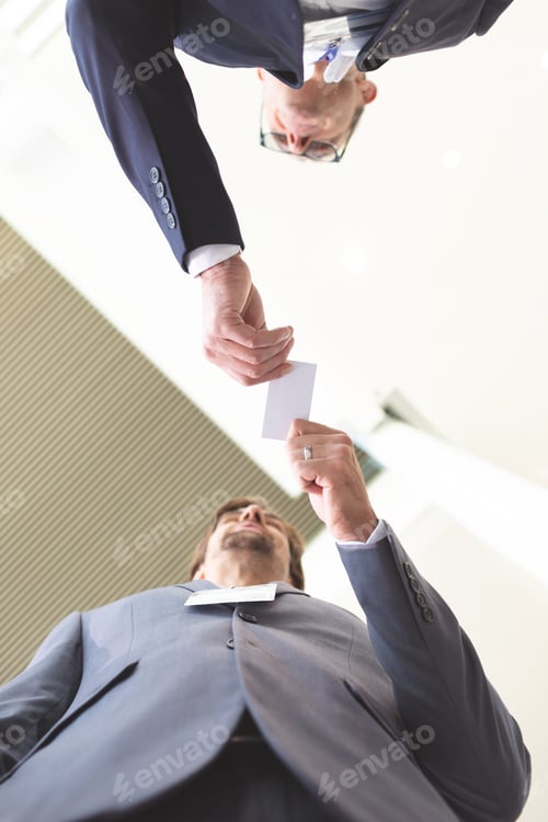 Preview: Upward view of diverse business people exchanging business card in conference