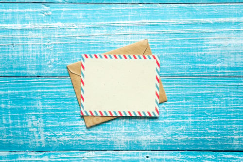 Preview: Envelope and postcard for text on a blue wooden background, top view.