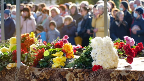Preview: Funerary urn with ashes of dead and flowers at funeral. Burial urn decorated with flowers and people