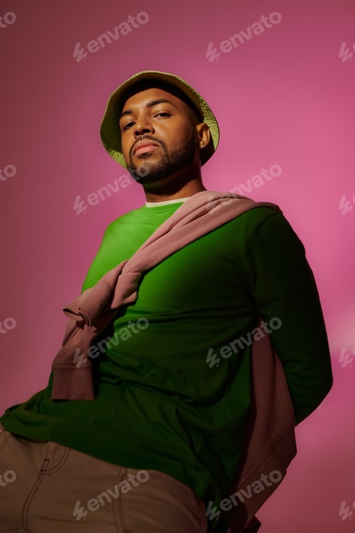 Preview: handsome african american man in green panama with beard looking at camera, fashion concept