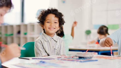 Preview: Portrait Of Smiling Male Elementary School Pupil Sitting In Classroom In Art Lesson