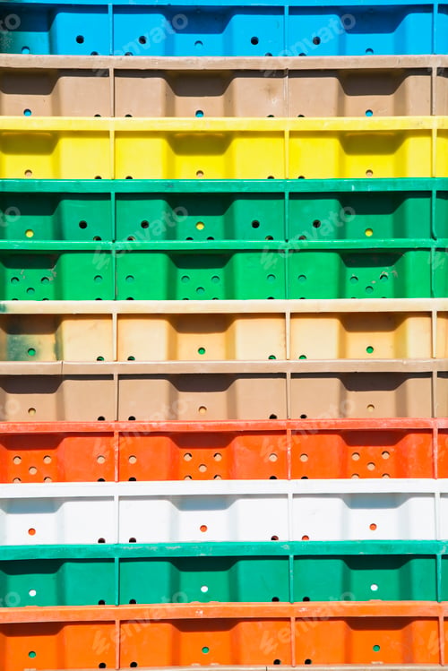 Preview: Stacks of multi-colored containers used for harvesting grapes