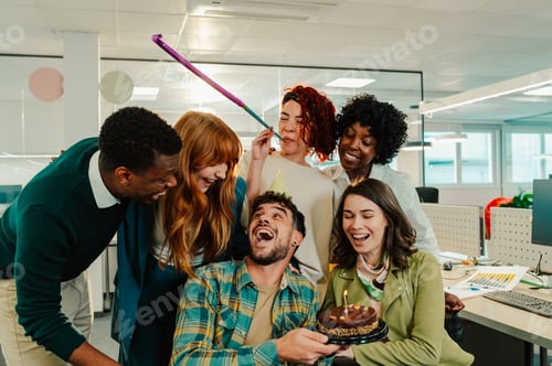 Preview: Business man celebrating birthday and having a party with diverse colleagues