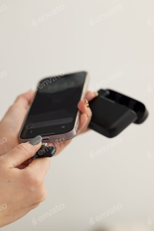 Preview: Young beautiful girl blogger preparing her smartphone for webinar and video recording