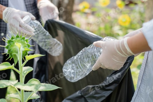Preview: garbage collection, volunteer team picking up plastic bottles, putting garbage in black garbage