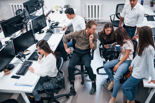 Preview: Young business people working together in the modern office