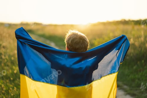 Preview: Ukrainian child boy in white t shirt with yellow and blue flag of Ukraine in field.