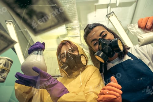 Preview: two young women chemists working at scientific laboratory with drugs, researchers in lab