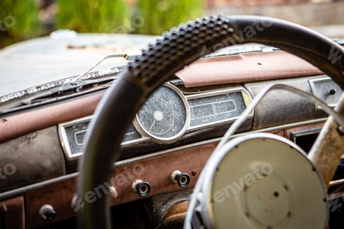 Preview: Vintage Car Dashboard Close-Up with Steering Wheel in Worn Condition