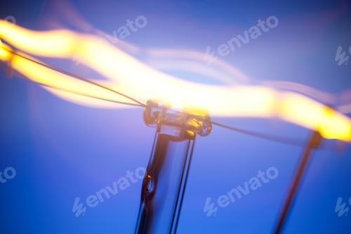Preview: Close-up of burning light bulb with tungsten filament in center