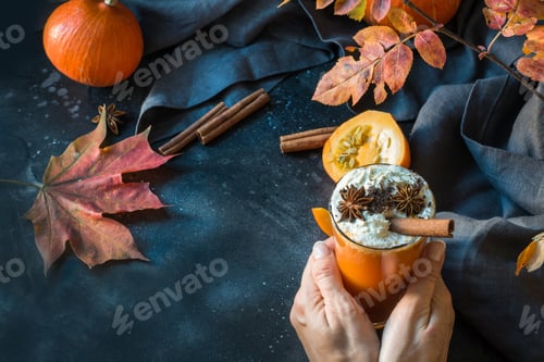 Preview: Fresh pumpkin spice smoothie or juice on dark. Autumn, fall or winter hot beverage