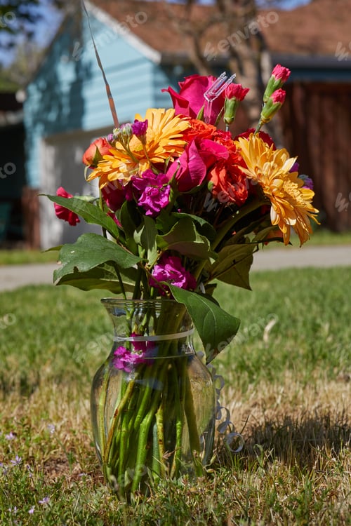 Preview: Vertical photo of colorful flowers in the vase at the garden
