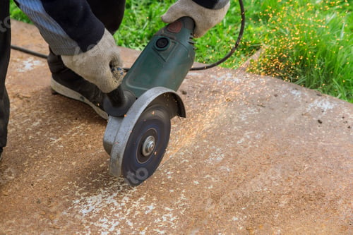 Preview: Worker cuting a metal surface with a hands saw