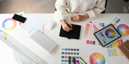 Preview: Top view of designer working in graphic design Choose colors for working with your computer at your