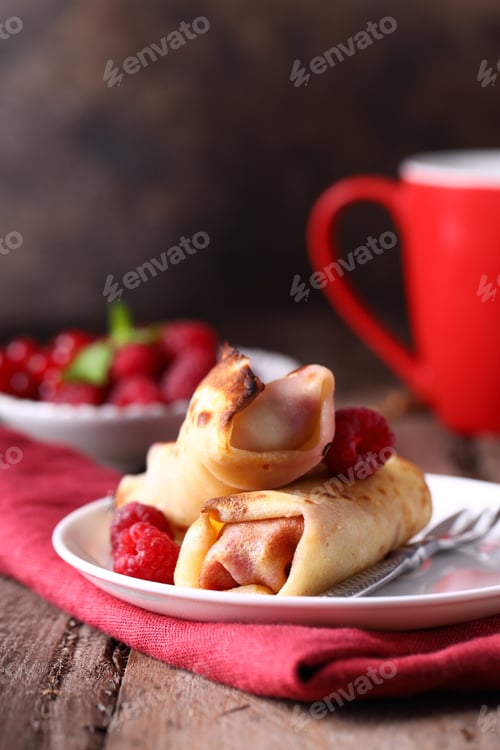 Crepe Rolls with Raspberries and Red Cup