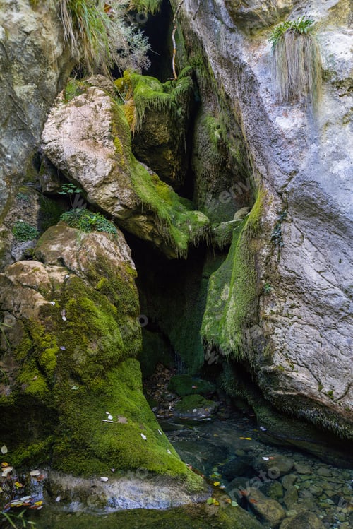 Preview: Waterfall in the rock covered with moss