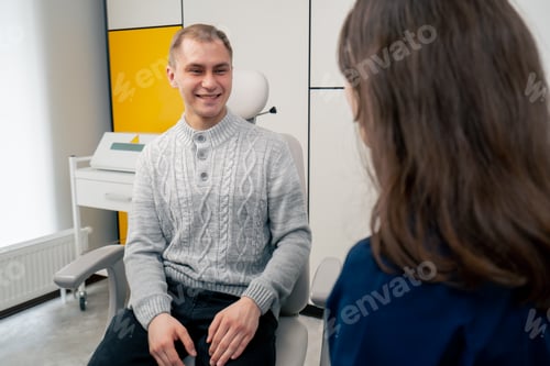 Preview: in the clinic a young ear throat nose doctor conducts a consultation for a young guy