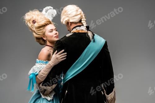 Preview: attractive victorian woman in blue dress hugging man in wig on grey