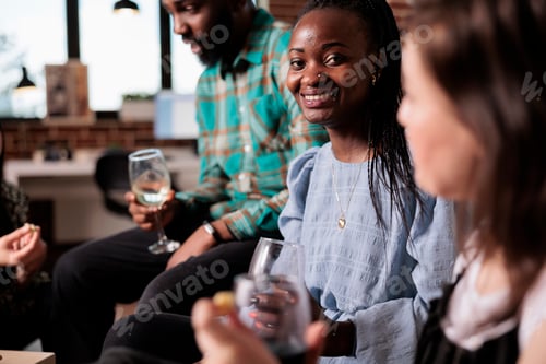 Preview: Cheerful woman smiling at camera while attending wine party celebrating best friend birthday