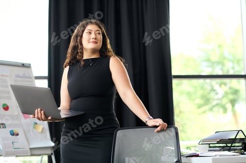 Preview: Confident plus-size woman in black leads business discussions in a modern office
