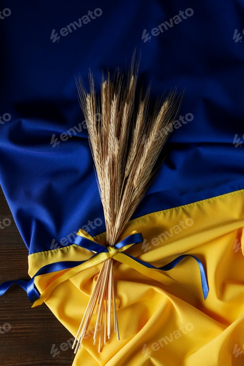 Preview: Ukrainian flag with spikelets with ribbons on wooden background