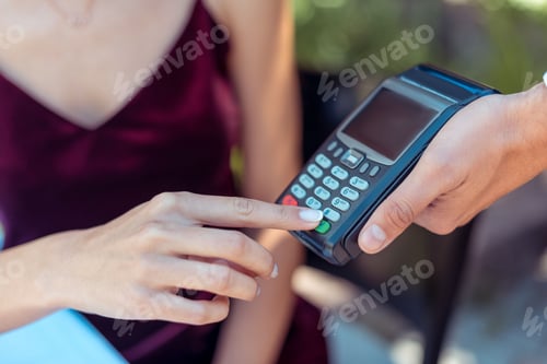 Preview: Close-up view woman entering pin code on pos terminal